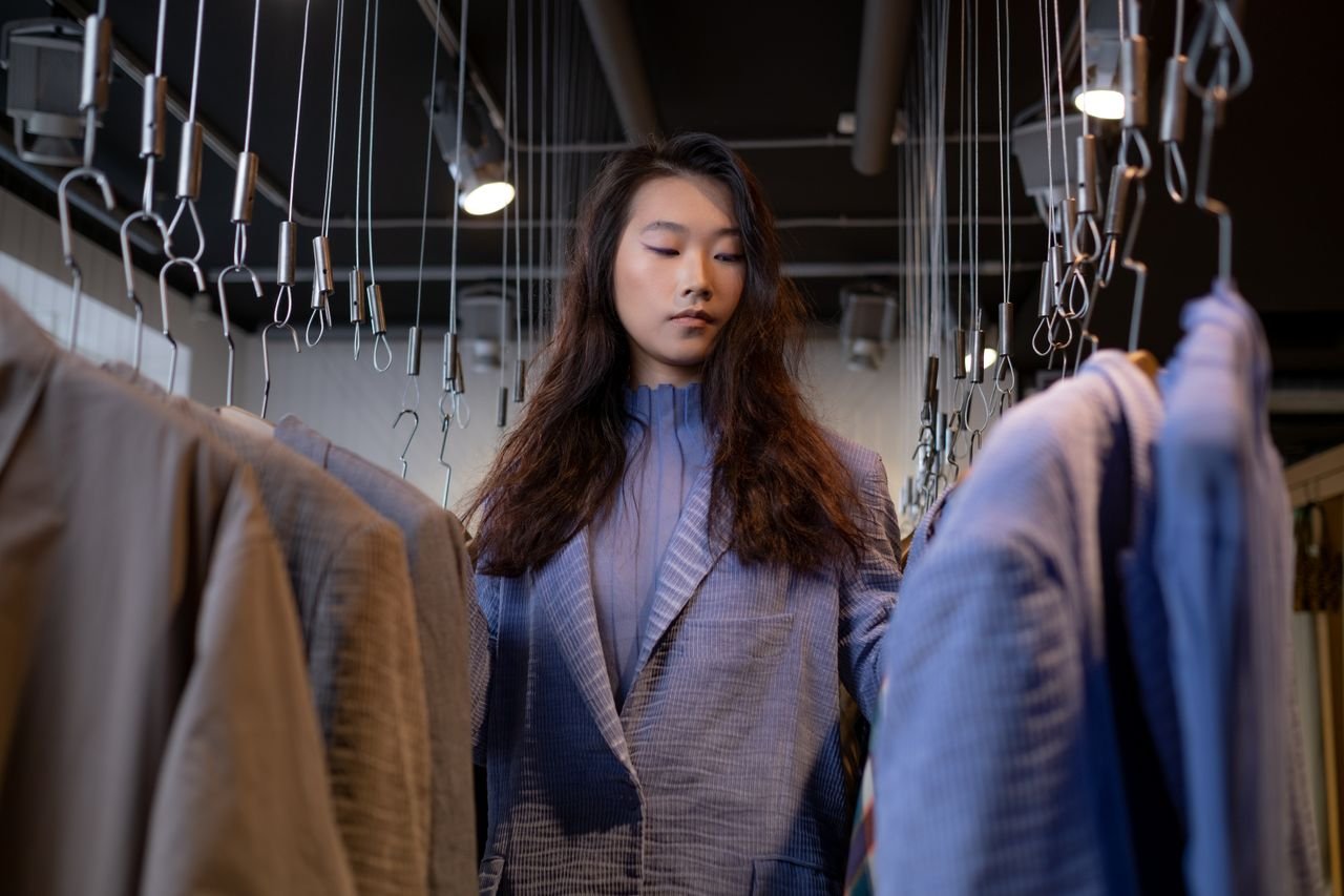 services-04 A stylish young woman browsing clothing options in a chic boutique.