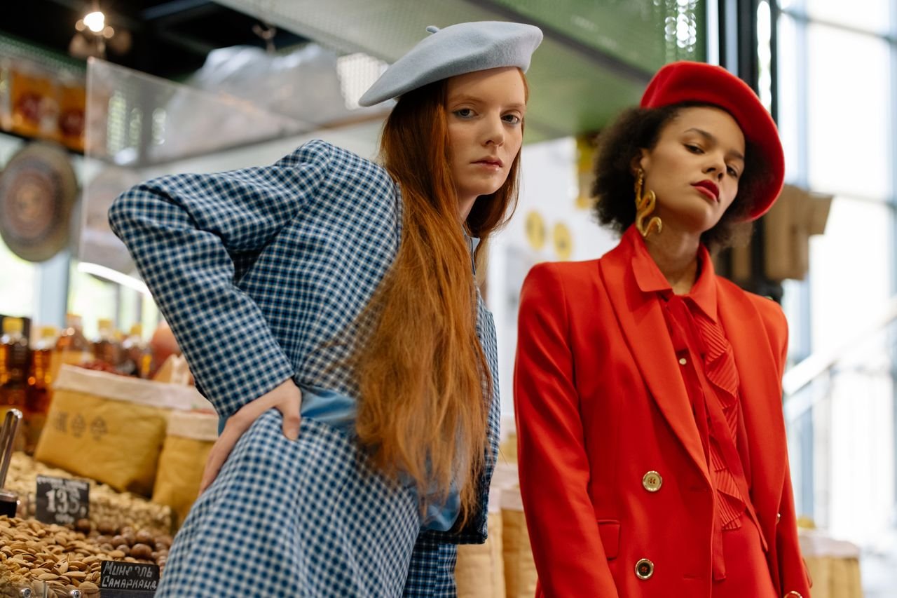 The Art of Drawing Readers In: Your attractive post title goes here Two stylish women in blazers and berets posing elegantly in a market.