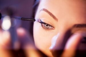 woman brushing eyelashes with volume using spoolie brush