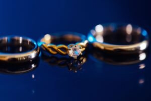 close up photo of a two tone engagement ring with white gold prongs and a rose gold band