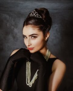 woman wearing a black Tahitian pearl multi strand necklace with a black evening dress