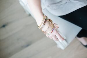 stacked custom friendship bracelets combining beaded and chain styles on one wrist