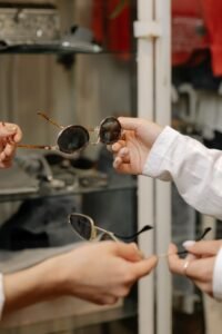  person checking the UV400 sticker on a pair of dark glasses