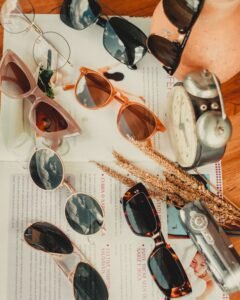 five sunglasses from different brands arranged in a row