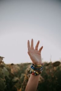 hand measuring wrist size with a paper strip for mom bracelet sizing