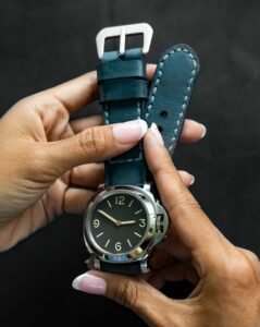 close up of hand stitched leather watch strap showing stamped tannery logo