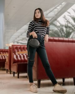 How to Wear a Belt Bag in 2026: The Complete Guide woman wearing a leather belt bag crossbody style over a white t-shirt and jeans