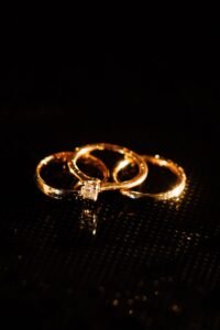 three engagement ring settings side by side, halo, solitaire, and three stone