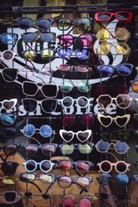 aviator, wayfarer, round, and cat eye sunglasses lined up on a white background