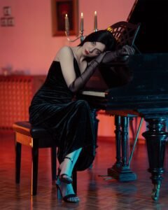 woman wearing black satin elbow gloves with an evening dress