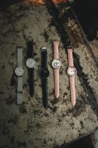 flat lay of five different watch bracelet materials including steel, mesh, and leather