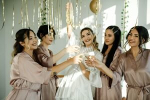 Bridesmaid Earrings: The Ultimate 2026 Gift Guide bride handing small gift boxes of matching earrings to bridesmaids at bridal shower