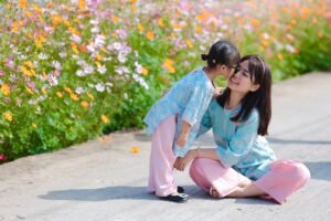 mother and daughter each wearing half of a matching heart pendant set