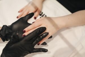 hands applying leather conditioner to a driving glove with a soft cloth