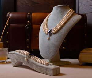 three strand graduated pearl necklace on a mannequin bust, front view