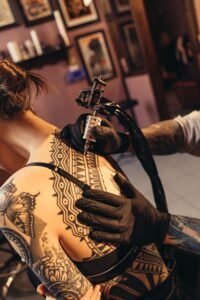woman with a fine line floral rib cage tattoo running along her side