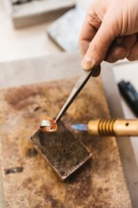 jeweler showing a client a finished custom ring under a loupe