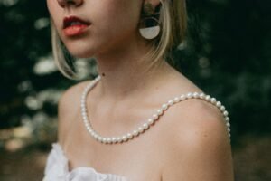 three pairs of pearl earrings with 14K, gold filled, and plated stamps shown side by side