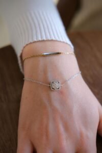 solid 14K gold bracelet next to a gold vermeil bracelet showing the same design