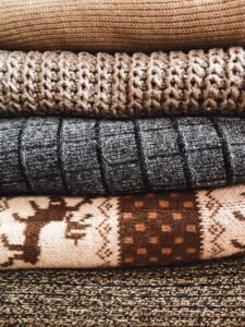 close up of three berets in wool, knit and leather, showing texture differences