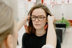 woman measuring cheekbone width with a soft tape to find sunglasses for face shape