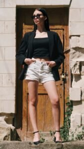 black square neck tank top styled under a blazer with a short gold chain
